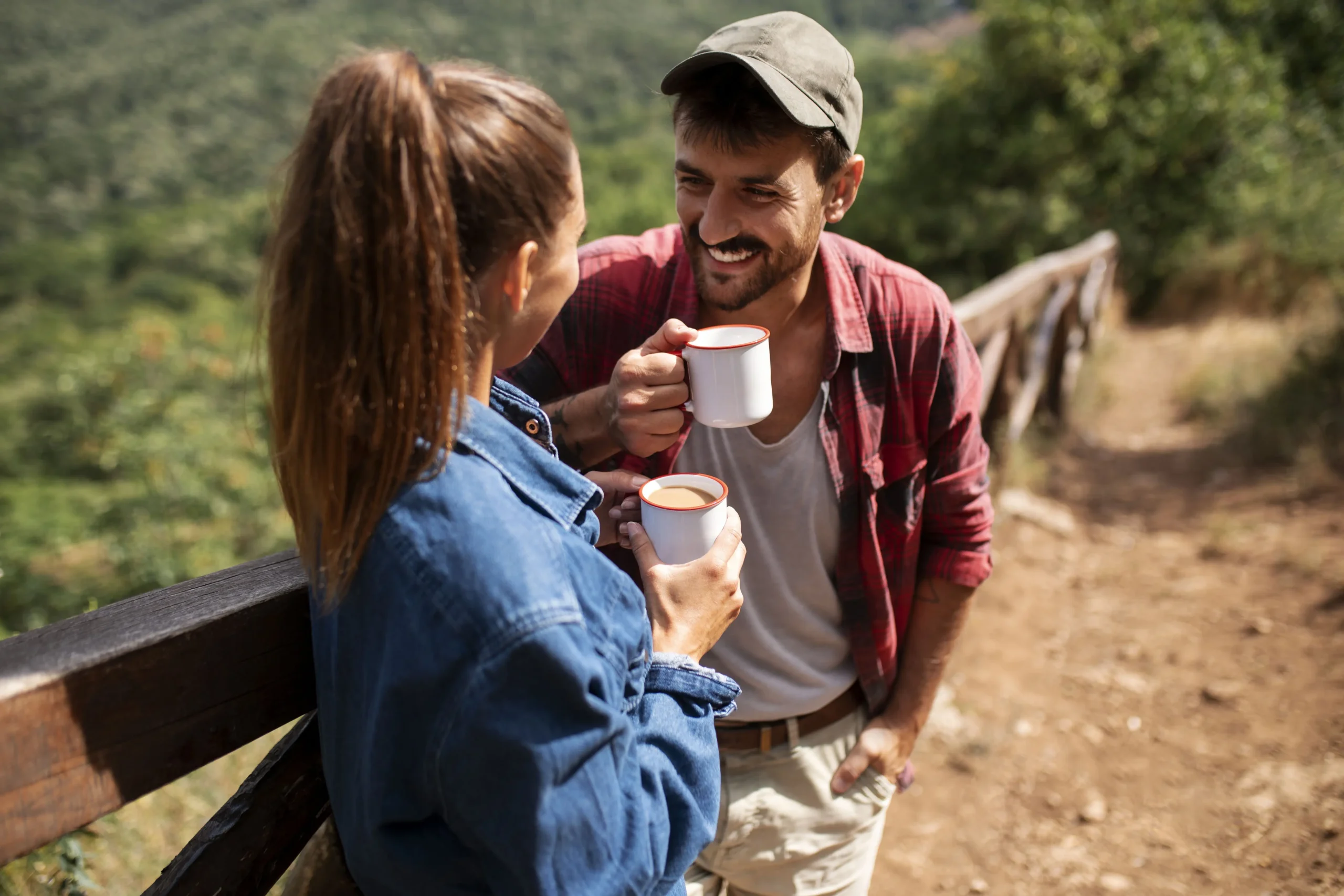 Couple Holding Mugs While Traveling Together In Nature 3 couple holding mugs while traveling together in nature 2