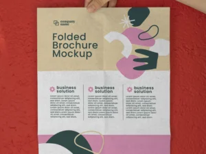female hand holding trifold brochure mock up with abstract shapes 1