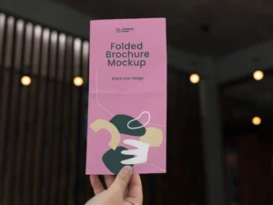 female hand holding trifold brochure mock up with abstract shapes 2