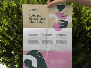 female hand holding trifold brochure mock up with abstract shapes 3
