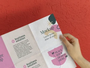female hand holding trifold brochure mock up with abstract shapes
