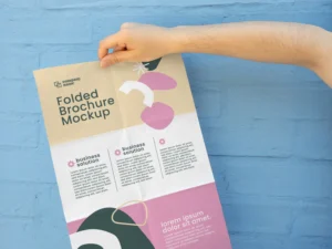 female hands holding trifold brochure mock up with abstract shapes 1
