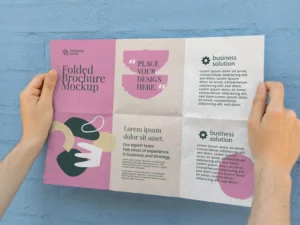 female hands holding trifold brochure mock up with abstract shapes 2