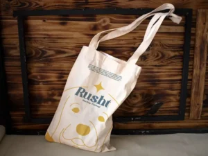 reusable tote bag mockup in wood background 1