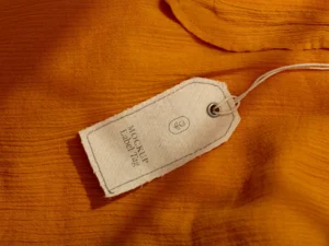 top view of clothing label mock up on orange textile